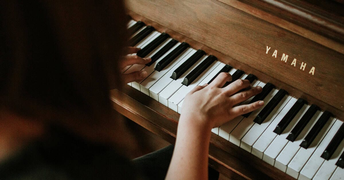 closeup of pianist's hands on piano