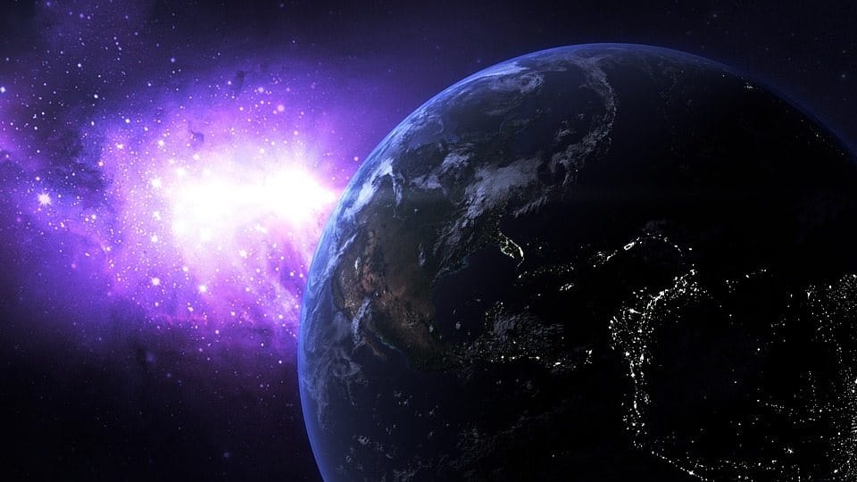 Vibrant view of Earth from space with a purple cosmic nebula in the background, showcasing the beauty of outer space and the planet's illuminated continents.