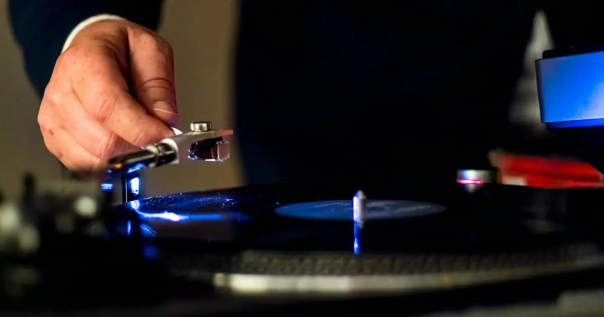 man playing record on a turntable