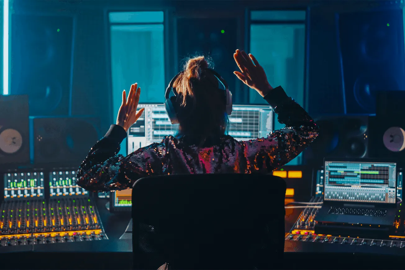Music producer working at digital audio workstation in recording studio with mixing consoles and speakers, high-tech music pr
