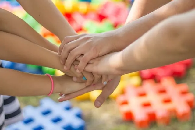 Hands stacked together, teamwork, unity, collaboration, diverse people, community support, group effort, teamwork concept.