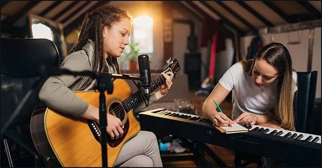 Young women musicians practicing in a cozy attic studio, one playing guitar and the other composing on a keyboard, embodying
